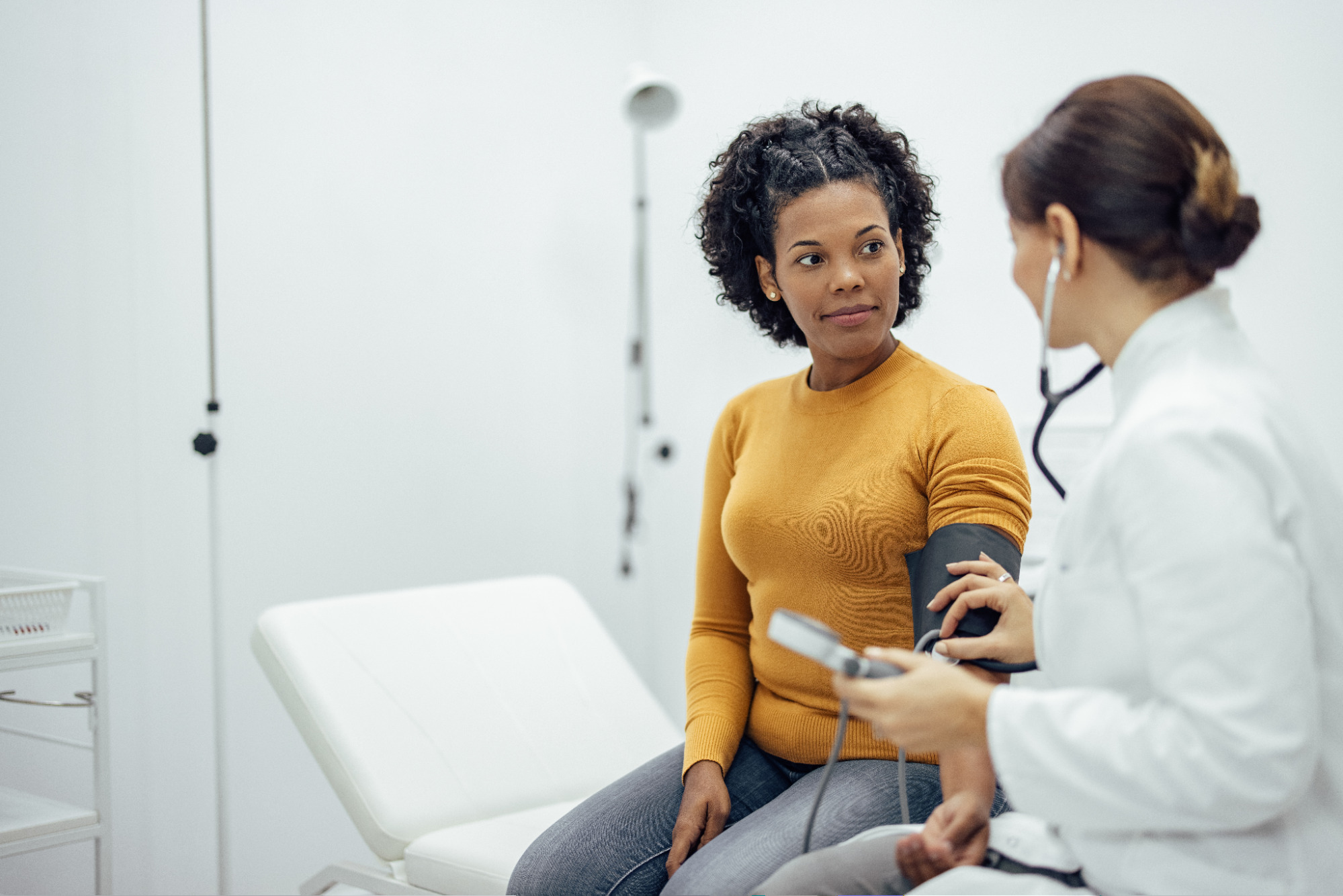 Doctor checking a patient's blood pressure during a primary care visit
