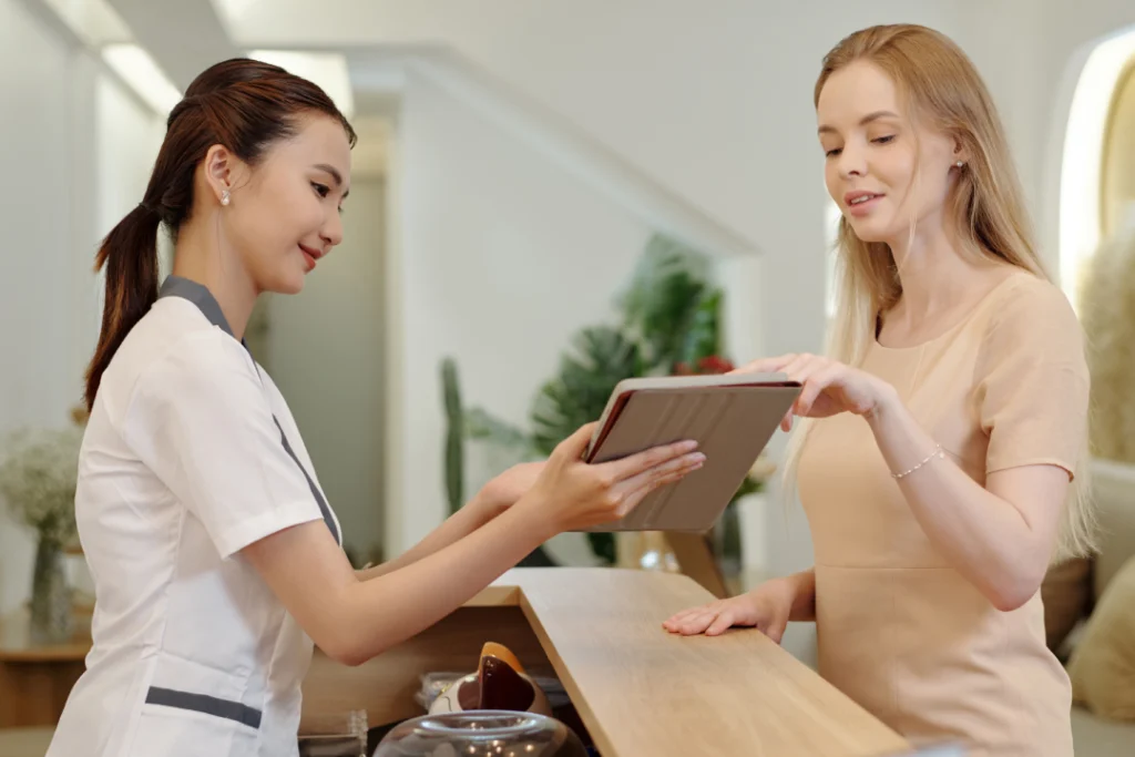 A receptionist assisting a client in booking an appointment for preventive care.