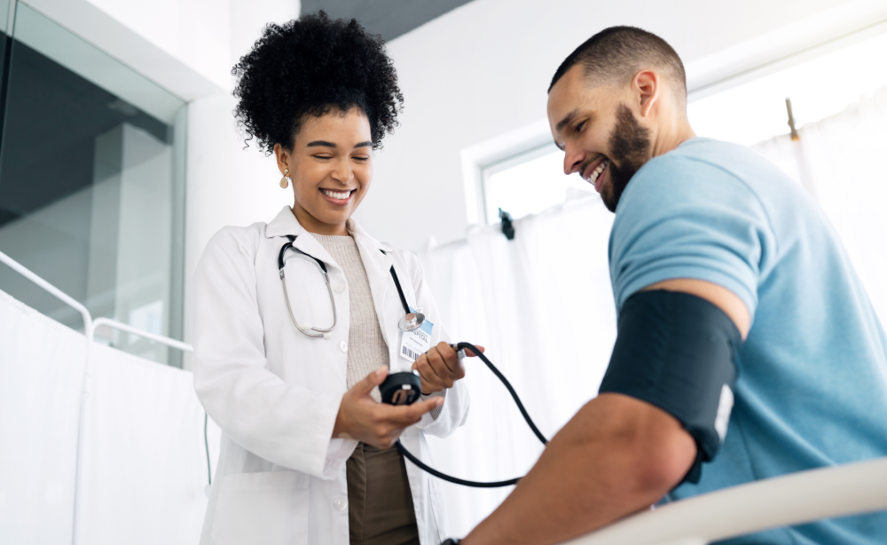 Doctor checking patient's blood pressure for Health Risk Management Week.