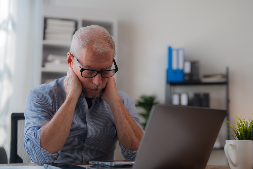 Stressed older man showing symptoms of health risk during Health Risk Management Week.