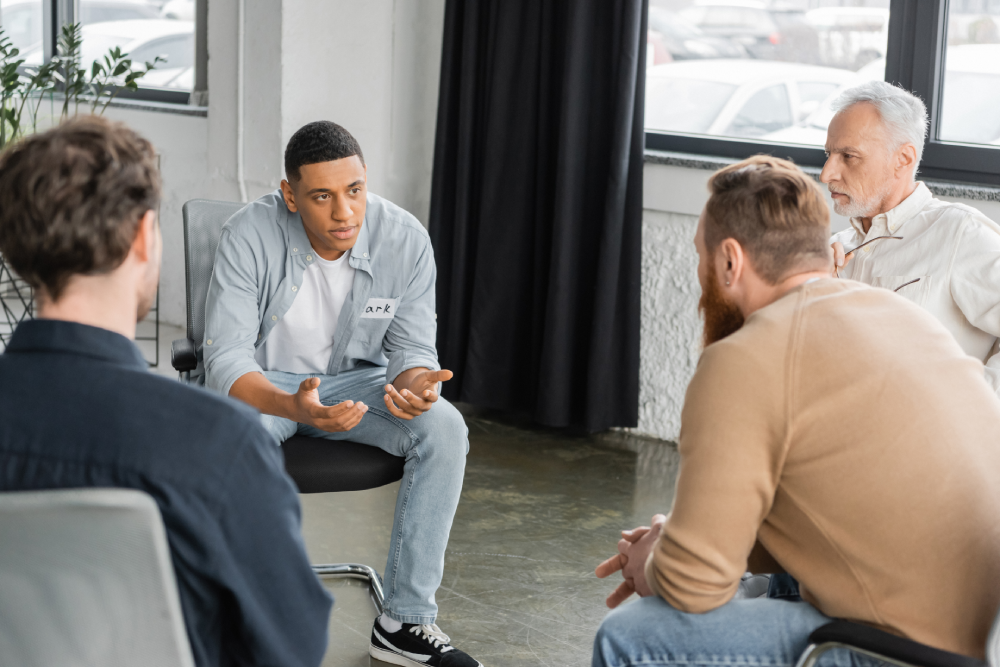 Men participating in a support group during Mental Health Awareness Month.